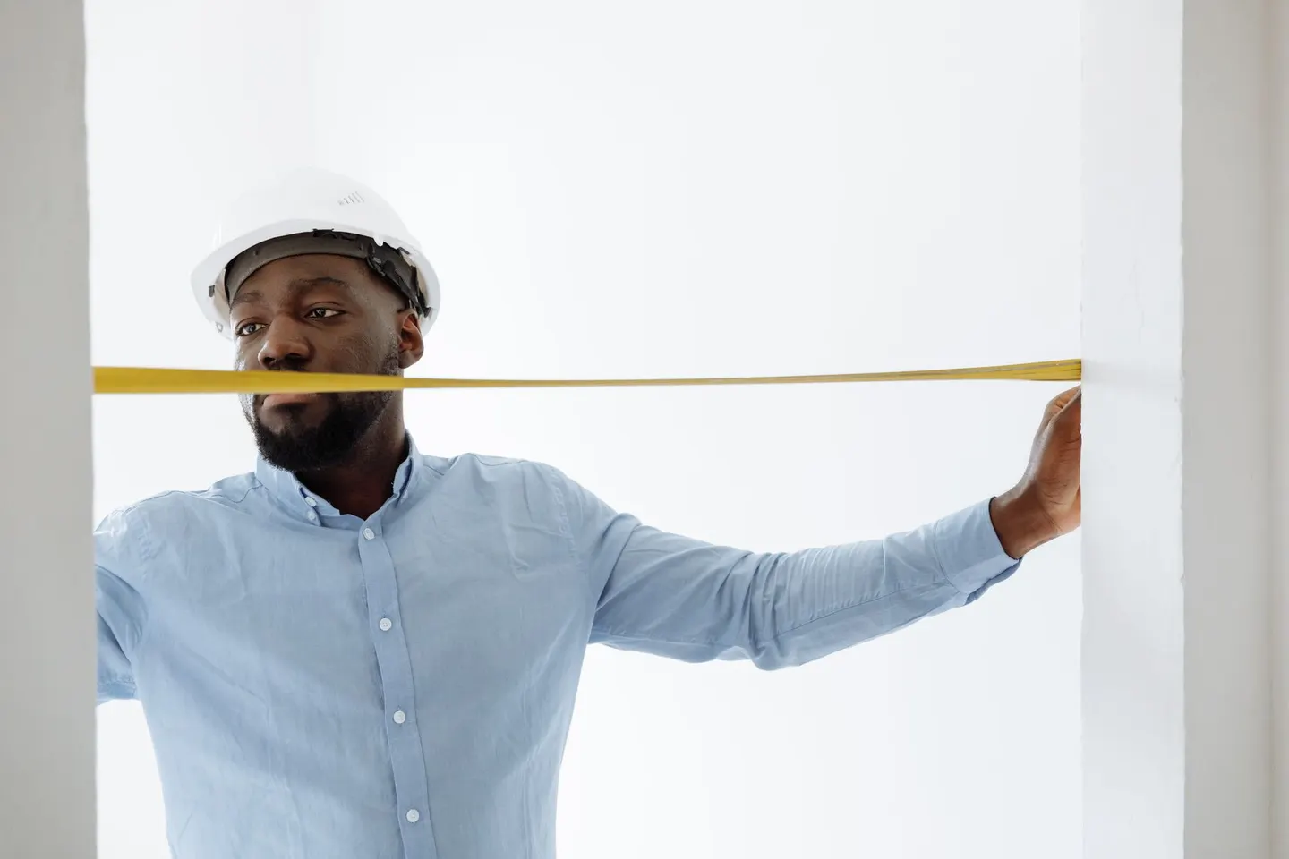 Contractor taking an indoor measurement